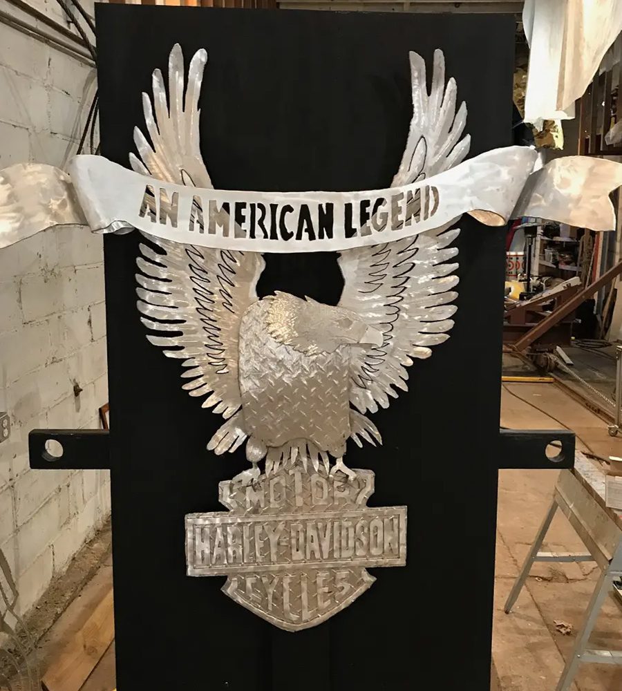 A metal eagle with the words " an american legend ".