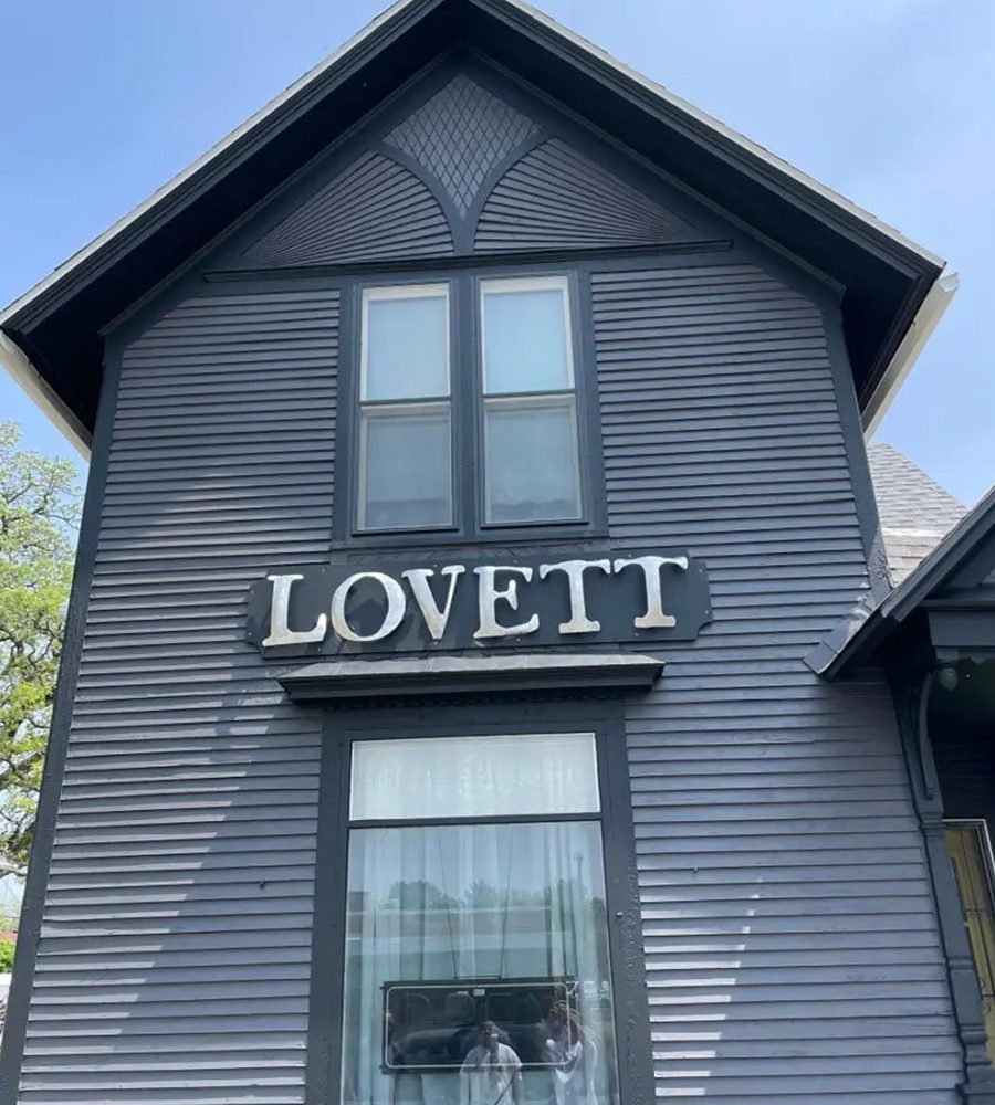 A black building with the word " lovett " on it.