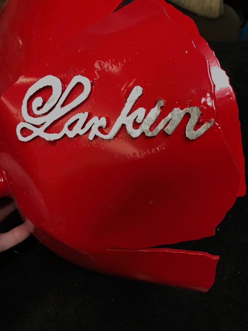 A red helmet with the name larkin on it.