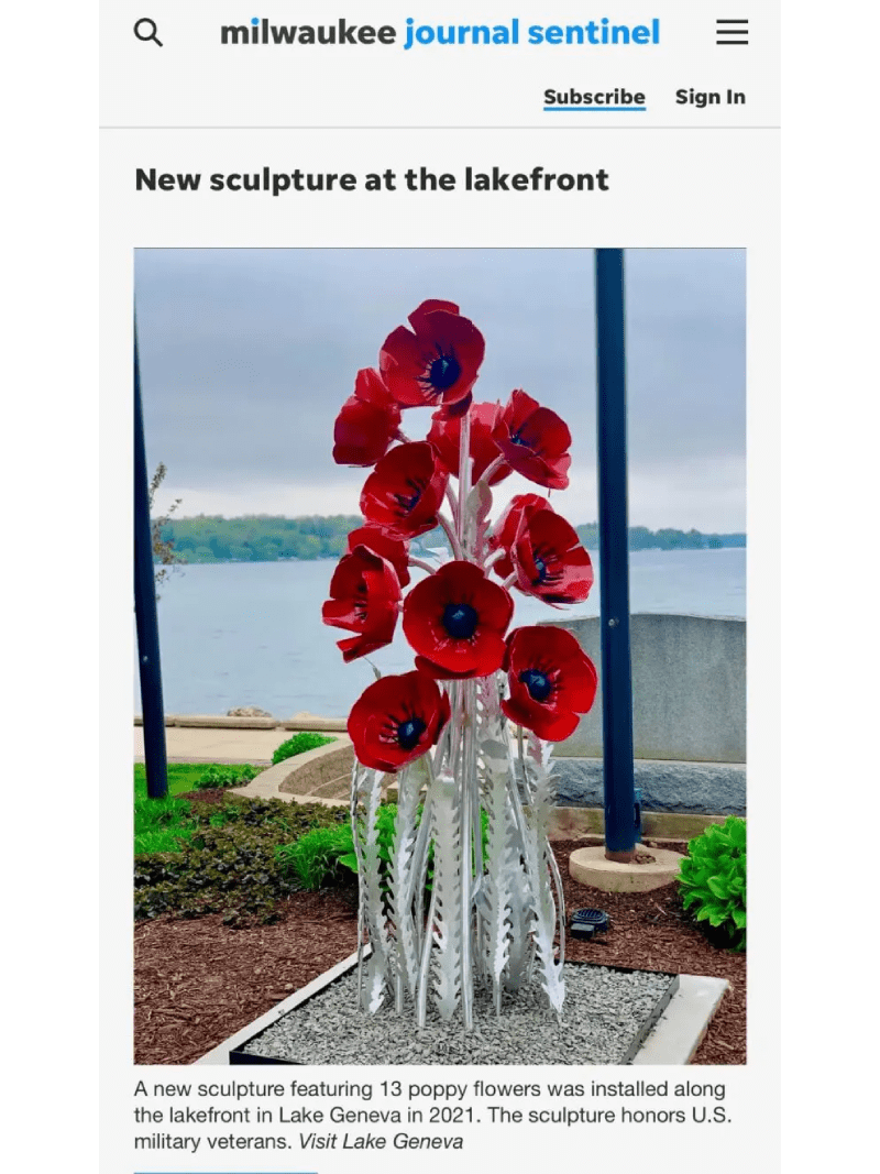 A sculpture of red flowers in the shape of a tree.