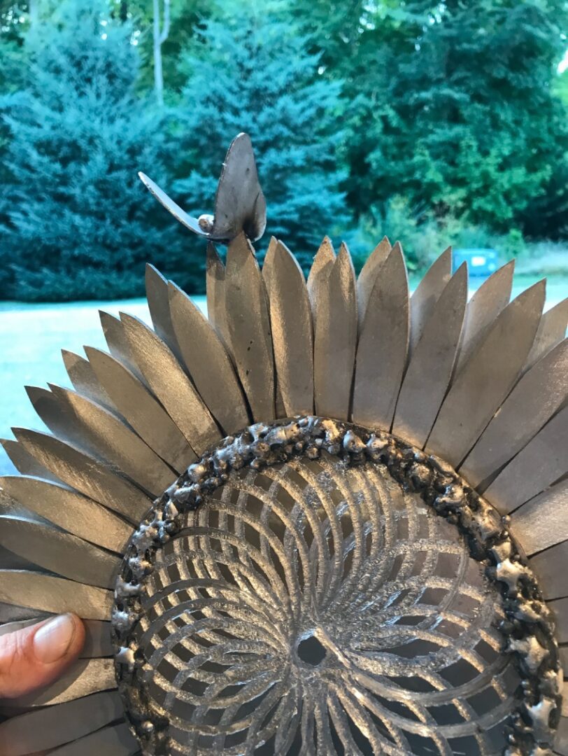 A bird is perched on top of an ornamental object.