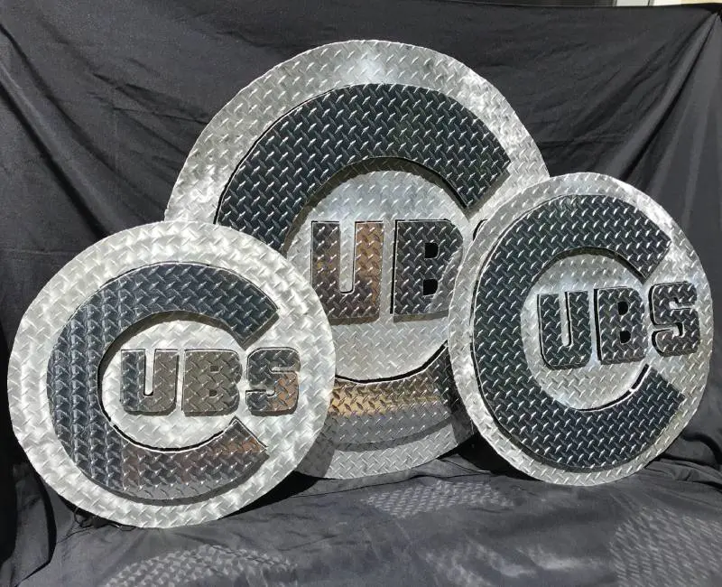 A group of three metal plates with the letters ubs on them.